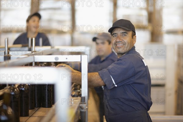 Hispanic man working in bottling factory