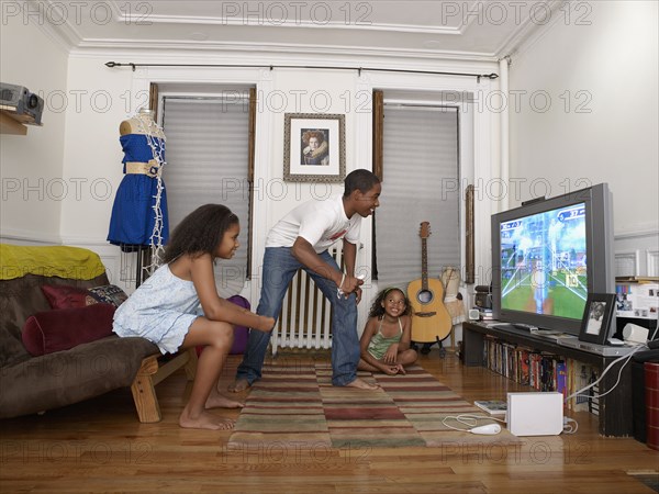 Brother and sister playing video game in living room