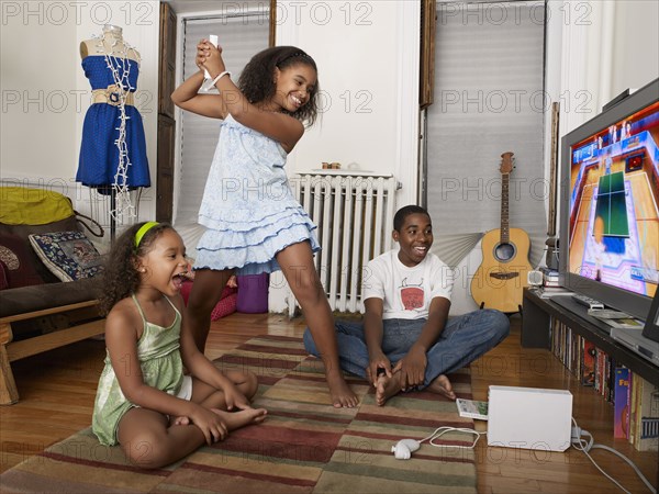 Sisters playing video games in living room