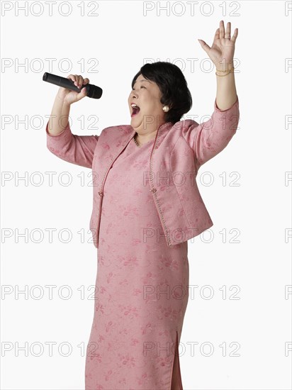 Confident Asian woman singing