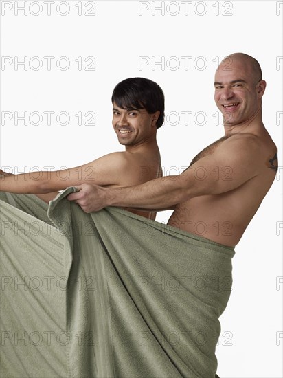 Nude men holding towel open