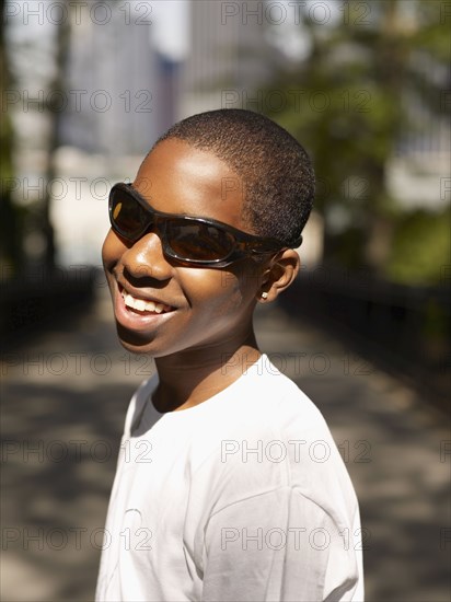 African teenage boy standing in urban park