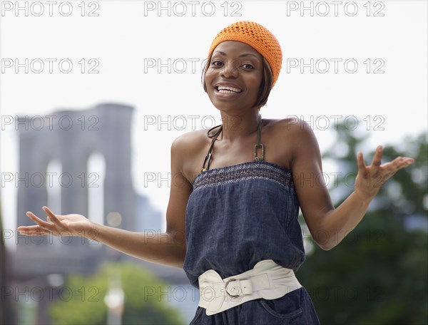 African woman gesturing questioningly in urban setting