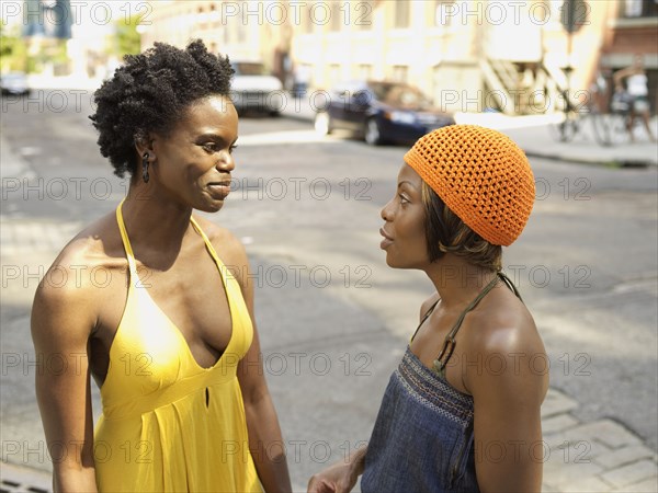 African woman talking to friend in urban setting