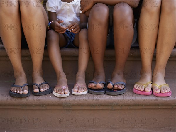 Close up of family's feet in flip flops