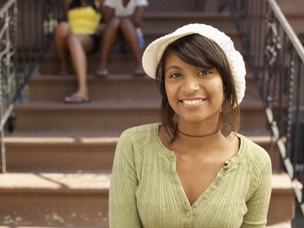 Smiling Hispanic woman with family in background