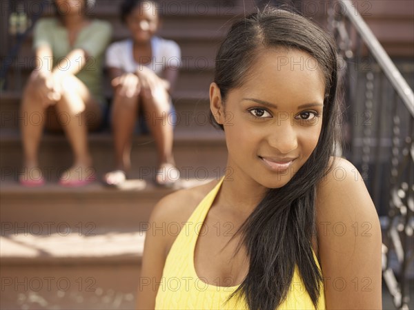 Smiling African woman with family in background