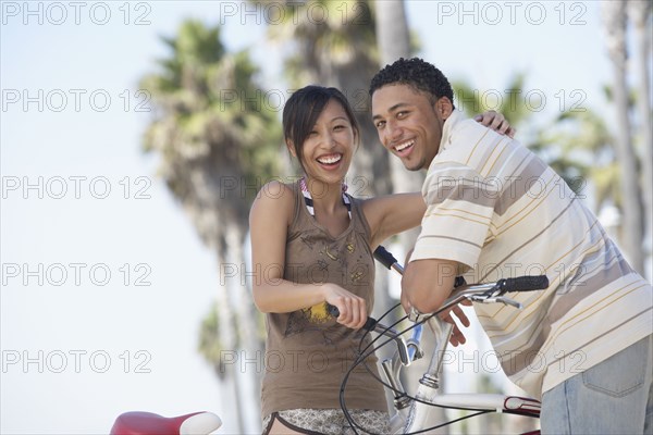 Young couple standing with bicycles