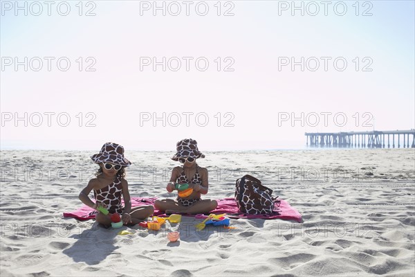 Young mixed race girls playing at beach