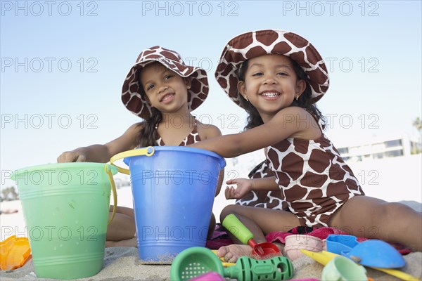 Young mixed race girls playing at beach