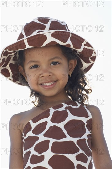 Young mixed race girl in bathing suit and hat