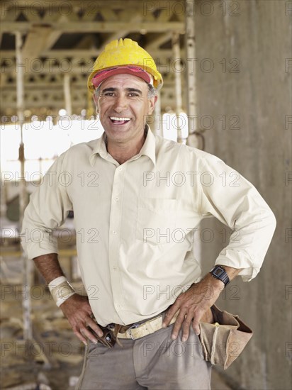 Hispanic worker smiling at construction site