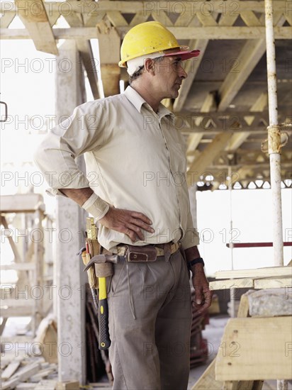 Hispanic worker standing at construction site