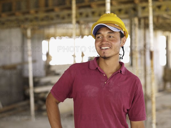 Hispanic worker smiling on construction site