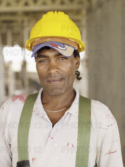 Hispanic worker smiling on construction site