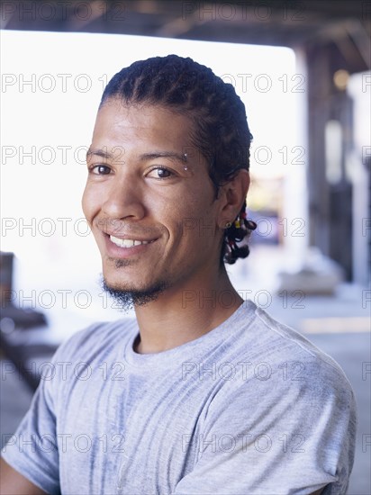 Hispanic worker smiling in factory