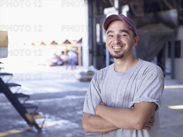 Hispanic worker smiling in factory