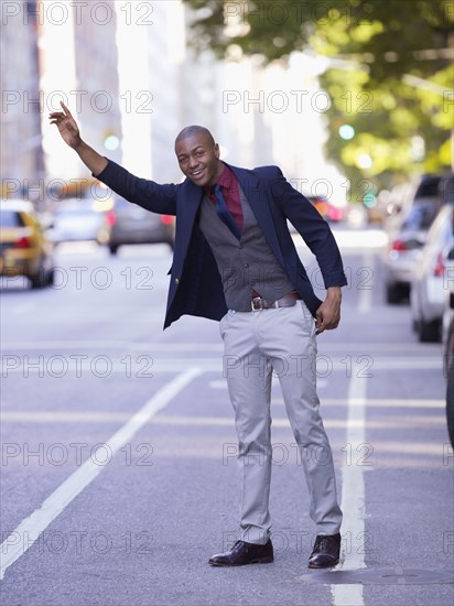 African businessman hailing taxi