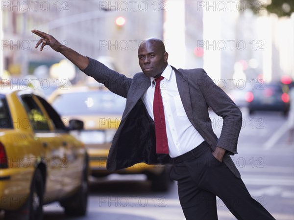 African businessman hailing taxi