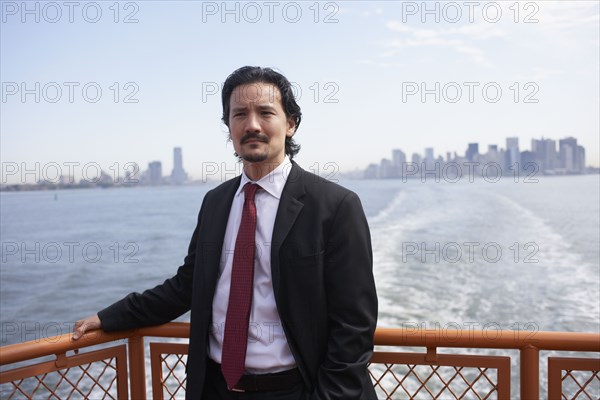 Mixed race businessman on ferry