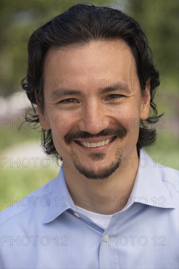 Close up of smiling mixed race man