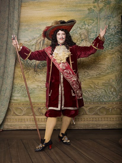 Actor dressed in old-fashioned costume on stage