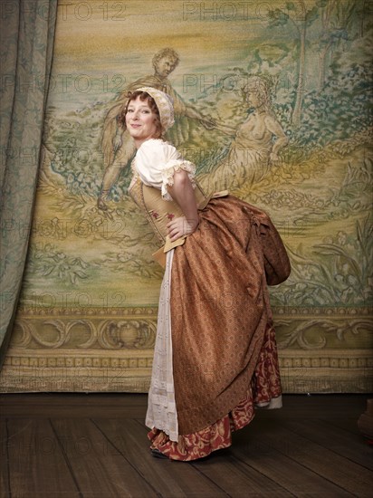 Actress dressed in old-fashioned costume on stage