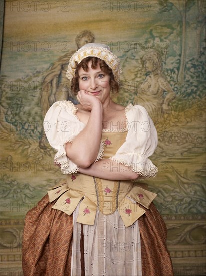 Actress dressed in old-fashioned costume on stage