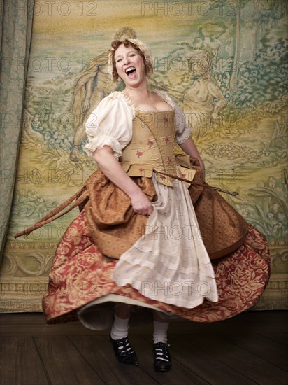 Actress dressed in old-fashioned costume on stage