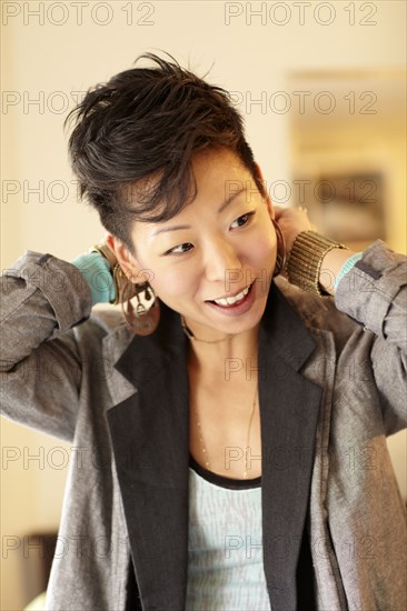 Smiling Korean woman dressing