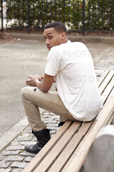 Haitian man sitting on bench