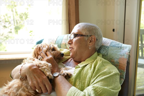 Caucasian woman holding dog