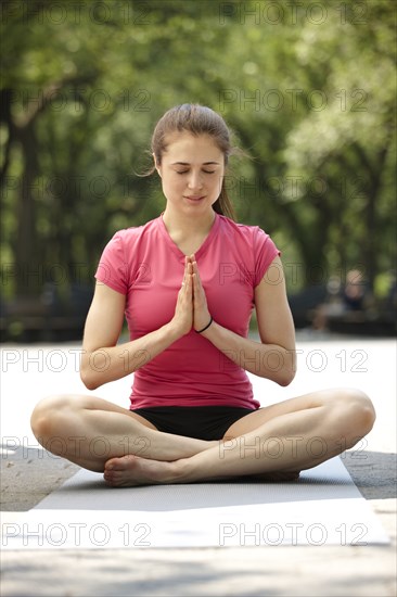 Caucasian woman practicing yoga in park