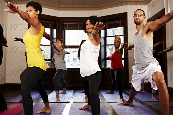 People practicing yoga in class