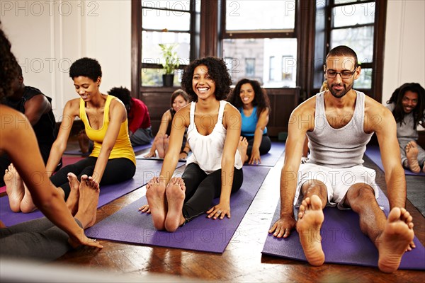 People practicing yoga in class