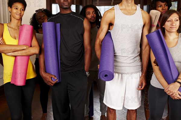 People holding yoga mats