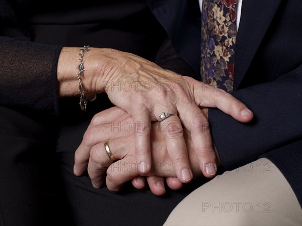 Close up of older couple's clasped hands