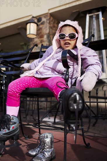 Mixed race girl wearing ice skates outdoors