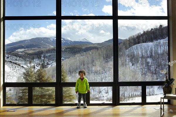 Mixed race girl standing in ski lodge