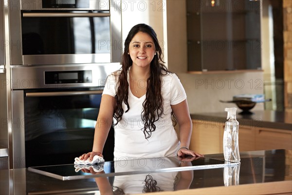 Hispanic woman cleaning kitchen