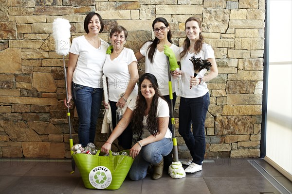 Hispanic cleaning crew smiling together