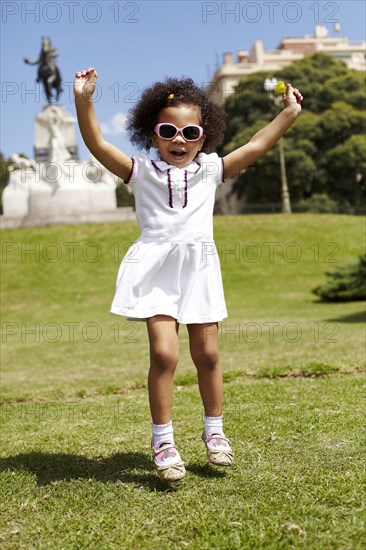 Mixed race girl playing in park