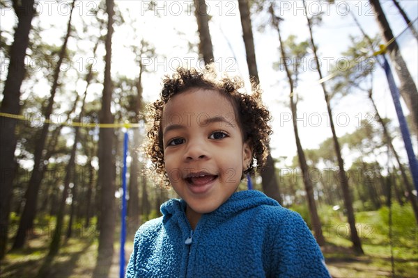 Mixed race girl jumping on trampoline