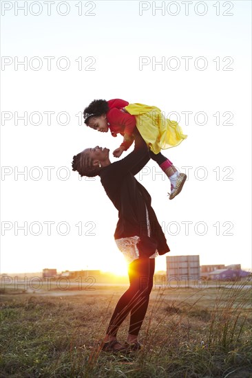 Mother playing with daughter on beach