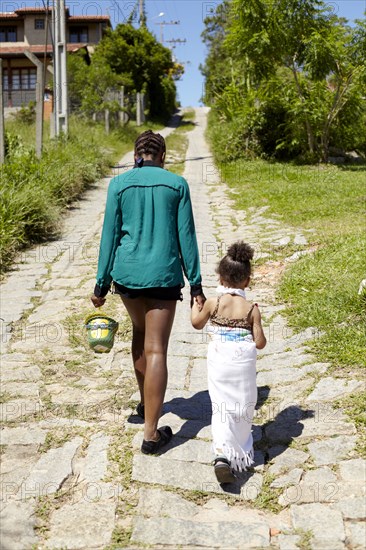 Mother and daughter on cobblestone street