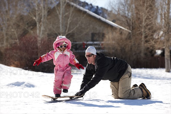 Father and daughter playing in snow