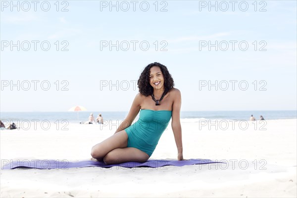 Mixed race woman relaxing on beach