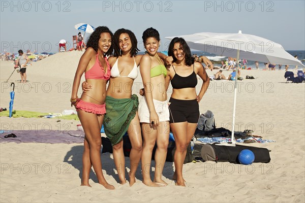 Women smiling together on beach