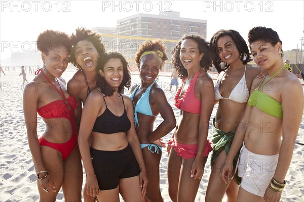 Women smiling together on beach