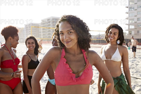 Women smiling together on beach